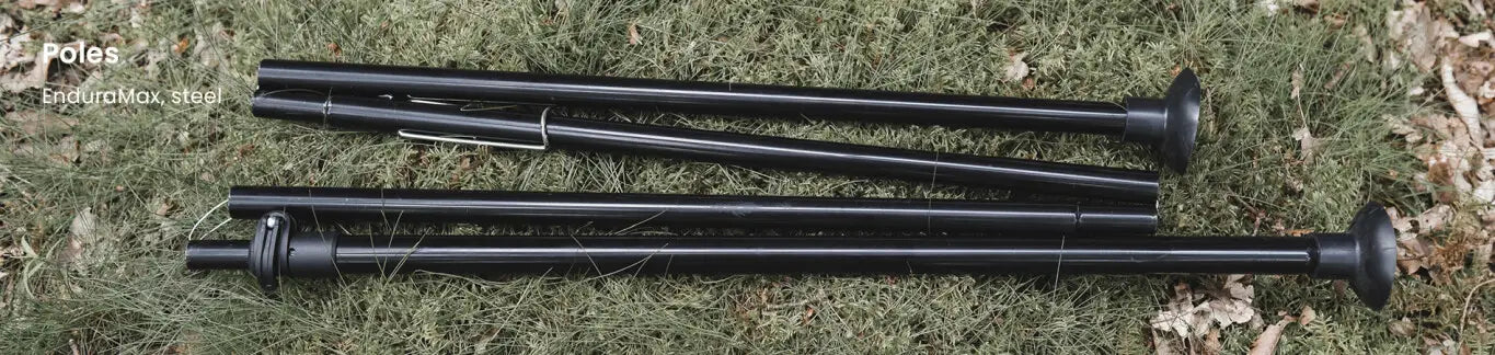 Easy Camp EnduraMax steel poles laid on grass, showcasing their strong and durable construction for reliable tent support.