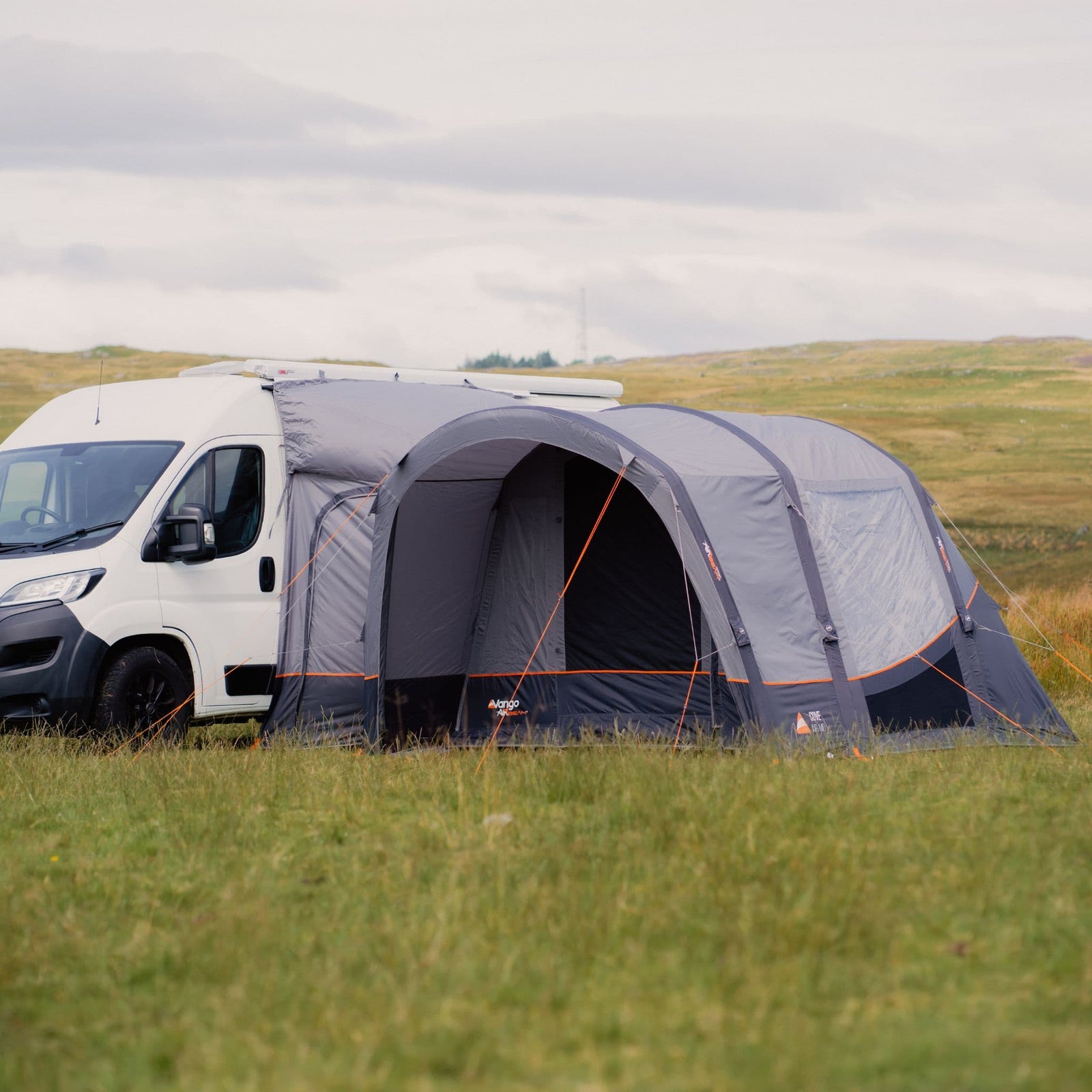 Side view of the Vango Cove III Air Mid Inflatable Awning attached to a motorhome, showcasing the spacious layout and durable materials.