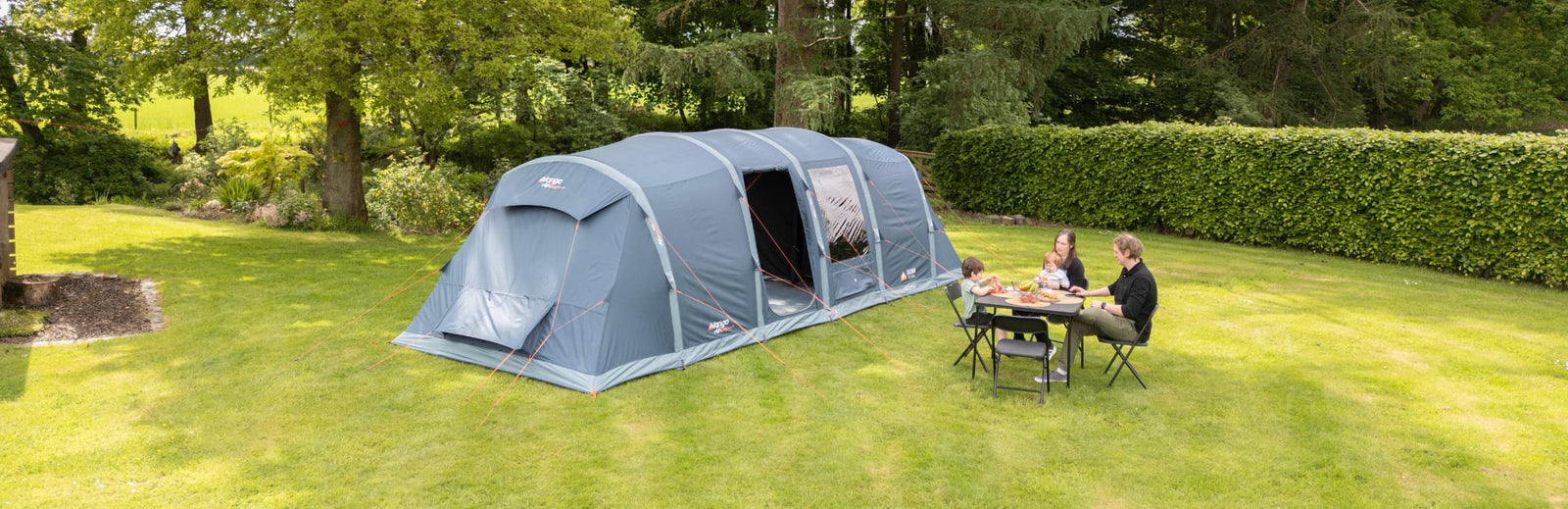 Vango Tacoma Air 800xl fully pitched with people eating outside at a camping table.