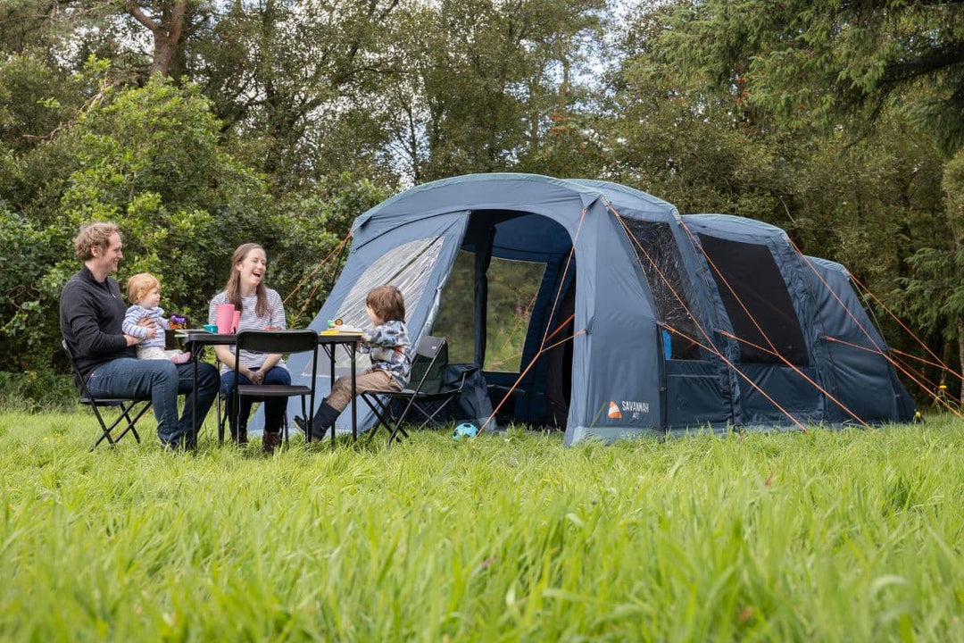 A family enjoying their camping trip outside a spacious 4 man inflatable tent, featuring durable fabric and a lightweight design. Ideal for compact 4 person tents with added comfort.