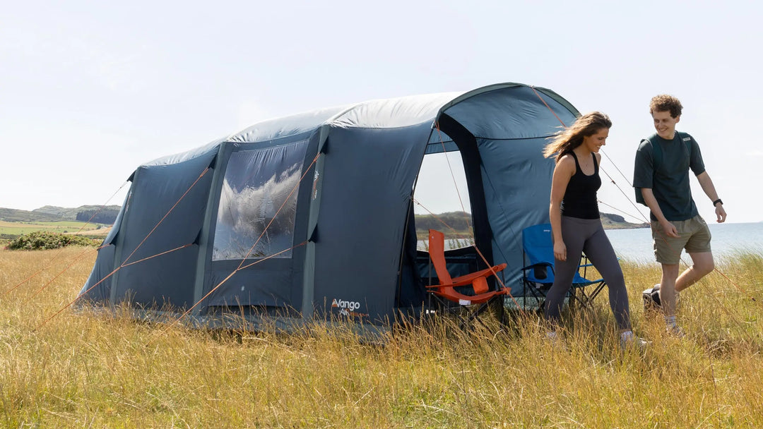 Vango Sierra Air 500 inflatable tent pitched on grass with outdoor seating, showcasing the convenience of Vango AirBeam technology in air tents.