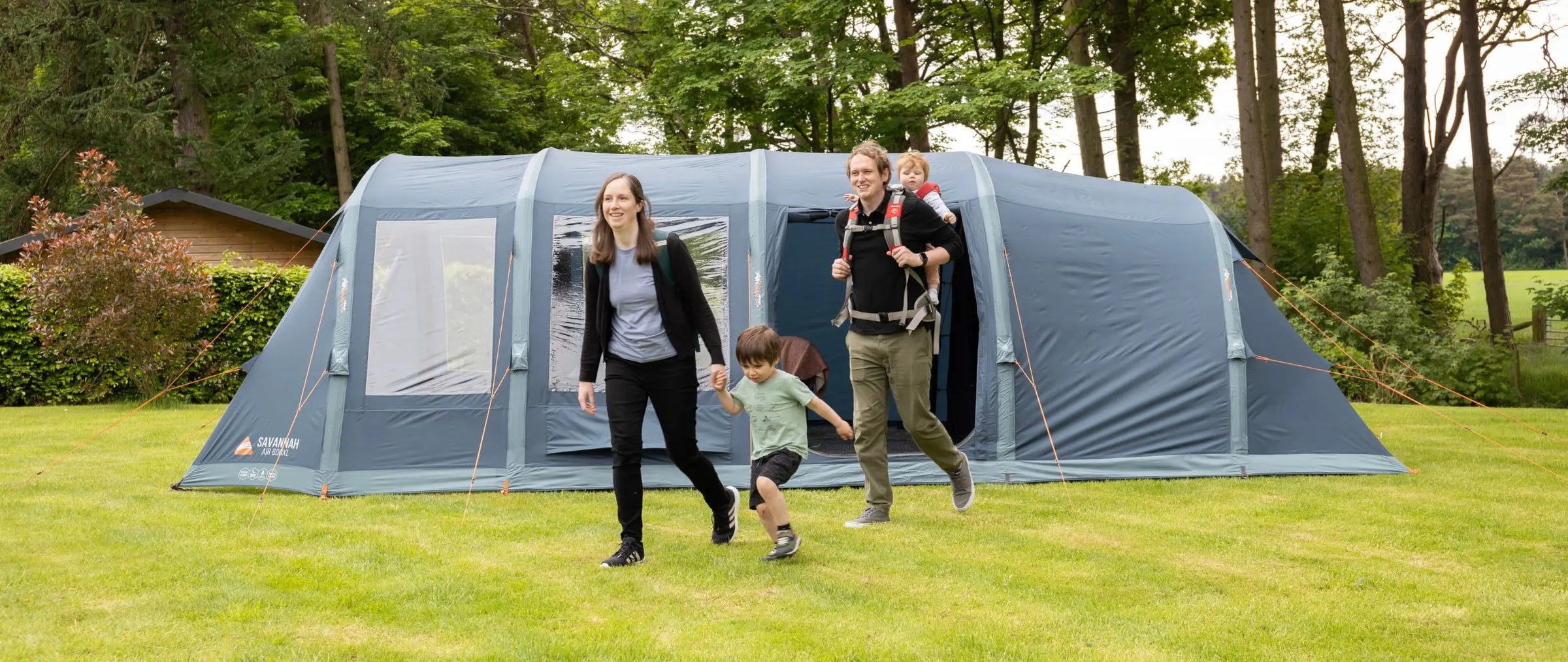 6 man air tent pitched on a family campsite.