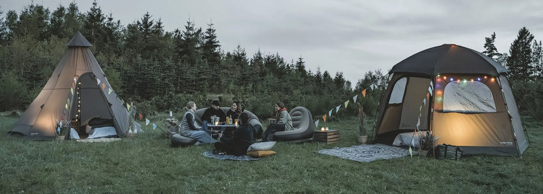 Two Easy Camp Tents pitched in a field with people camping outside