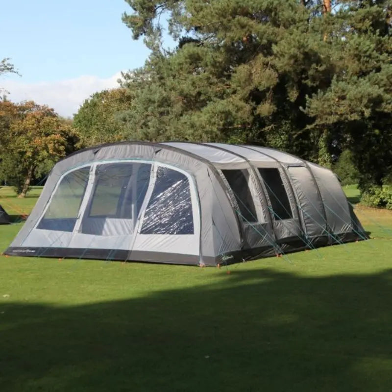 Large Outdoor Revolution Camp Star 700 tent on grass with trees in the background.
