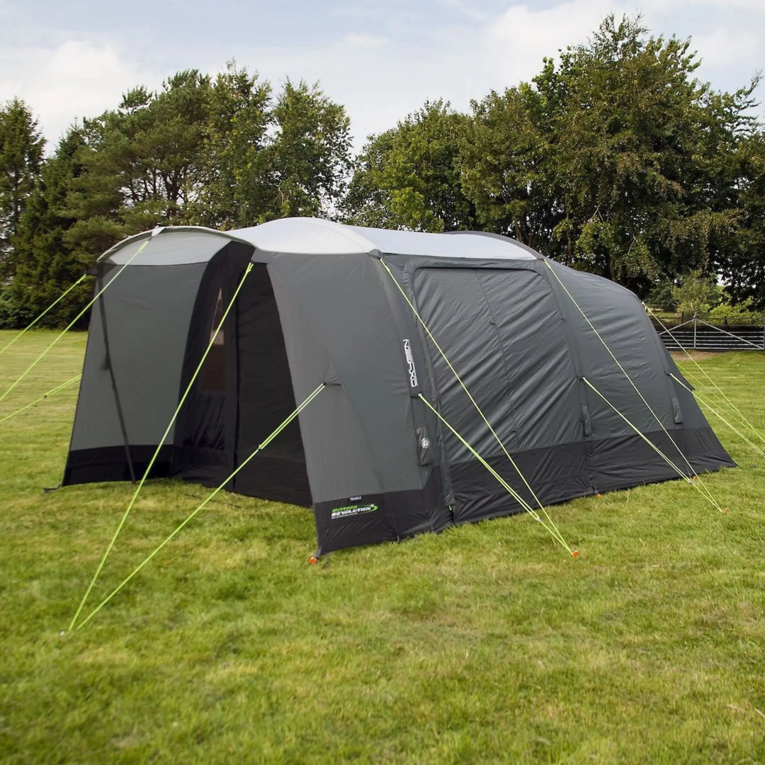 Outdoor Revolution Airedale 400T Air Tent on a grassy field with trees in the background
