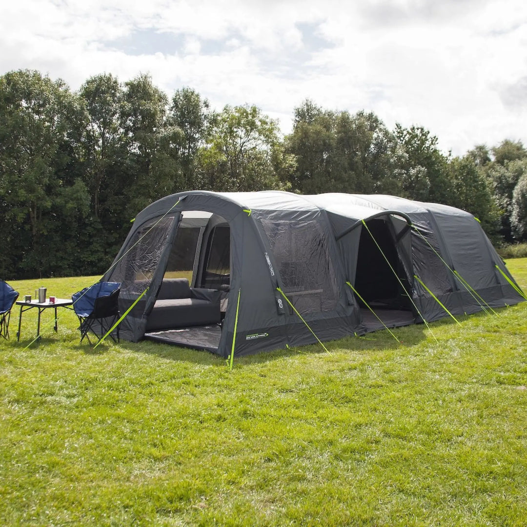Outdoor Revolution Airedale 6.0s Tent with pre-attached porch on a grassy field with trees in the background