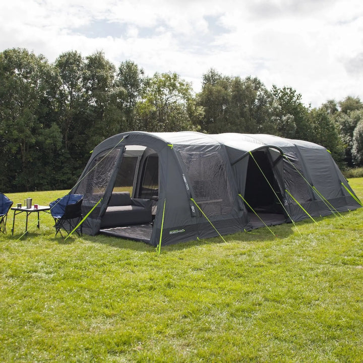 Outdoor Revolution Airedale 6.0s Tent with pre-attached porch on a grassy field with trees in the background