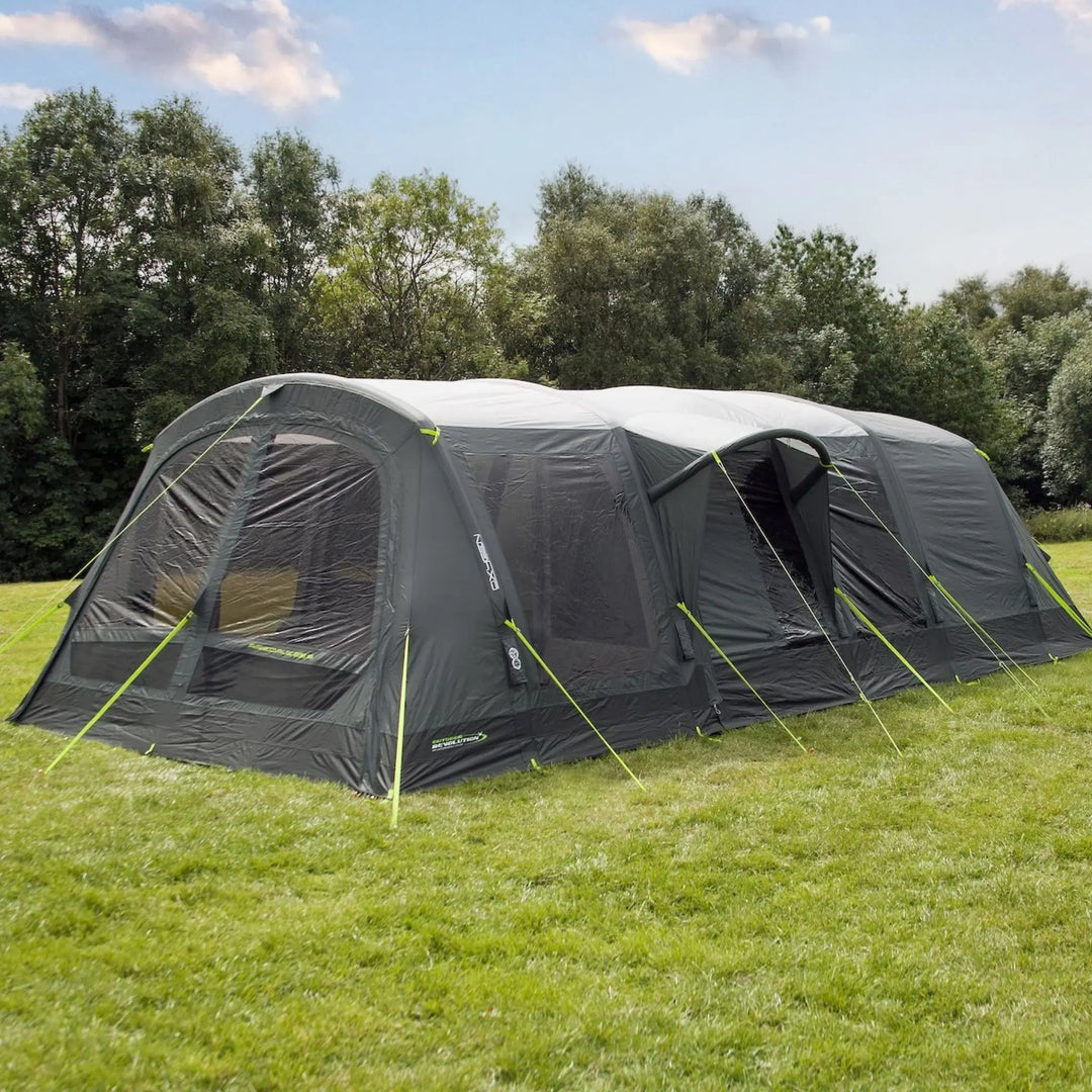 Outdoor Revolution Airedale 6.0s Tent with pre-attached porch on a grassy area with trees in the background