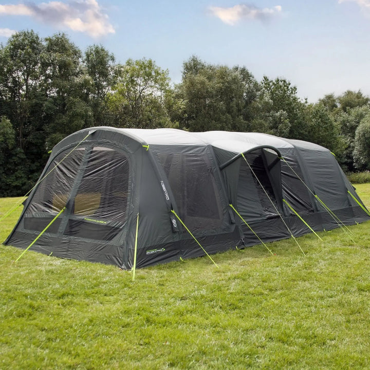 Outdoor Revolution Airedale 6.0s Tent with pre-attached porch on a grassy area with trees in the background