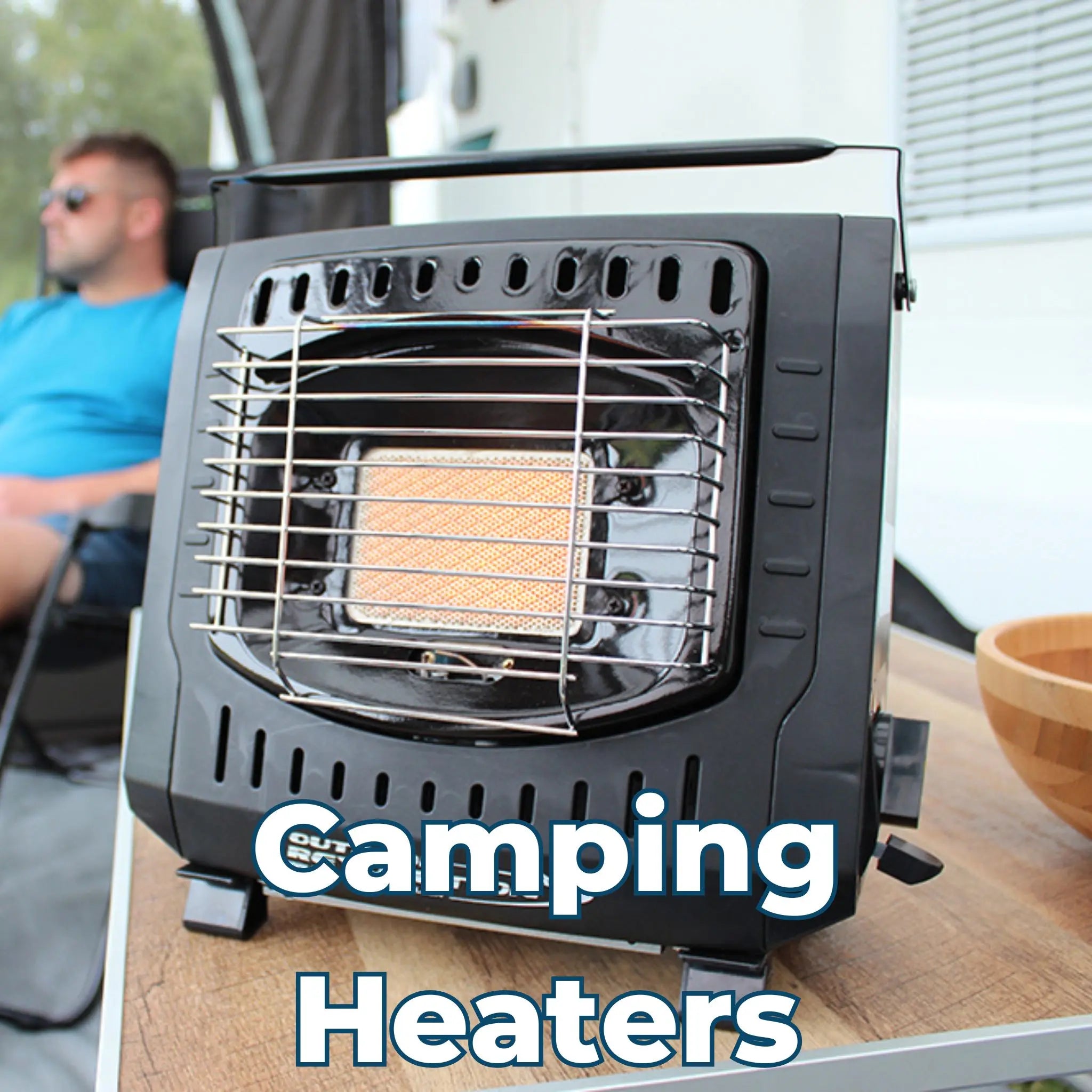 Camping Heaters – A compact black camping heater on a wooden surface, with a person relaxing in the background.