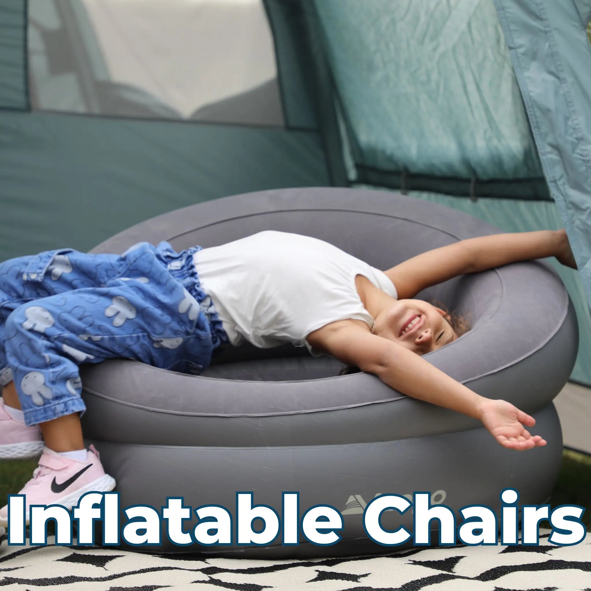 Child lounging on a Vango inflatable chair inside a tent, enjoying a soft and comfortable seating option for camping.