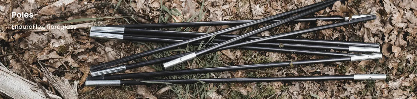 EnduraFlex fibreglass tent poles lying on the ground, highlighting the durable and flexible frame structure of the Easy Camp Skarvan 6 family tent.