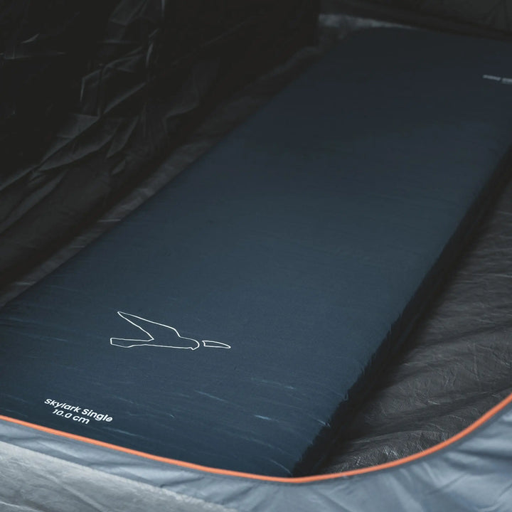 Easy Camp Skylark Mat Single 10cm Self Inflating Mattress inside a tent bedroom with brand logo on a camping mattress