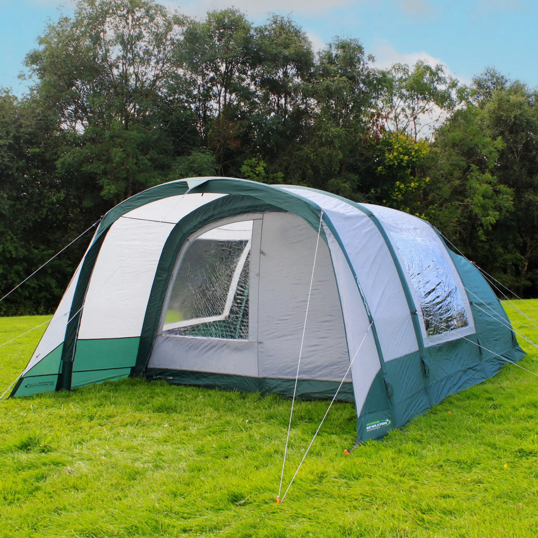 Outdoor Revolution Atom 500 Air Tent pitched in a scenic outdoor setting with trees in the background.