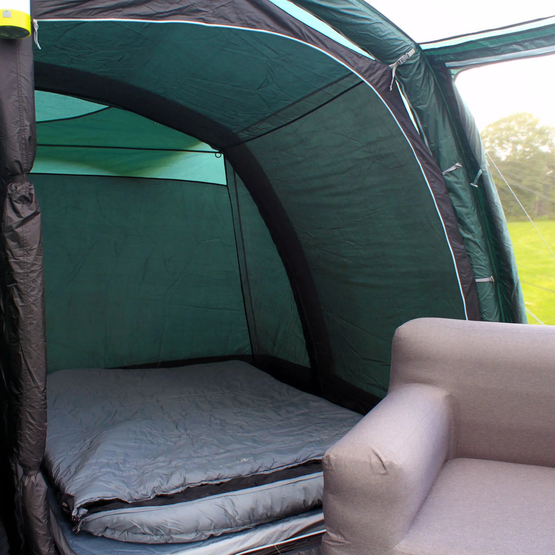 Bedroom compartment inside the Outdoor Revolution Atom 600 Air Tent with sleeping mats and furniture.