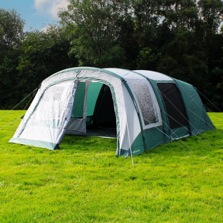 Outdoor Revolution Atom 600 Air Tent pitched on grass with front door open, showcasing the spacious entrance.