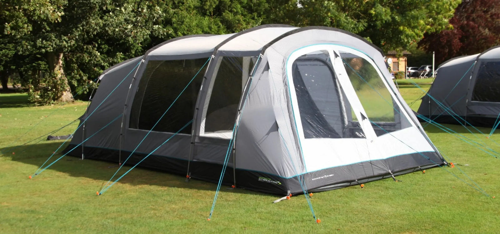 Outdoor Revolution Camp Star 500XL DT poled tent set up on grass, featuring large PVC windows, a spacious living area, and multiple guy ropes for stability.