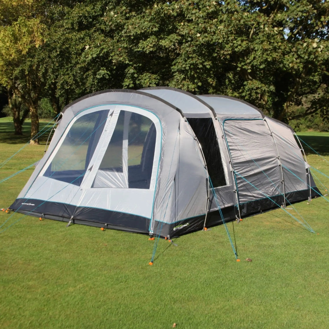 Spacious Outdoor Revolution Camp Star 500XL DT poled tent set up on grass, featuring large windows and multiple guy lines for stability.