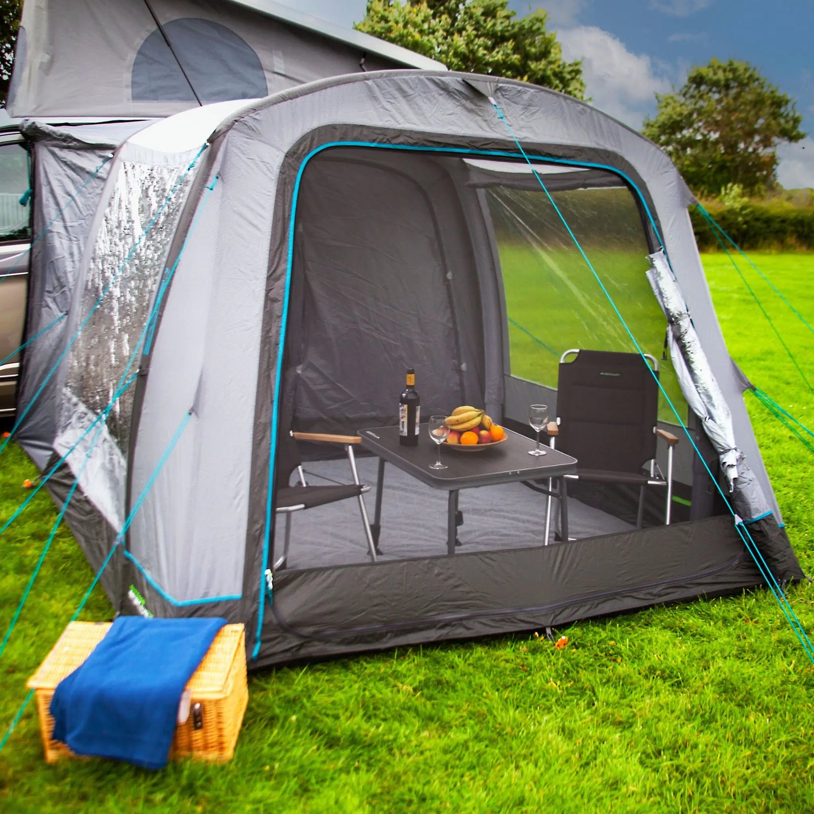 A close-up view of the Outdoor Revolution Cayman Air T2 Low campervan awning. The robust inflatable structure offers a stable setup, while the mesh panel front door helps with ventilation.