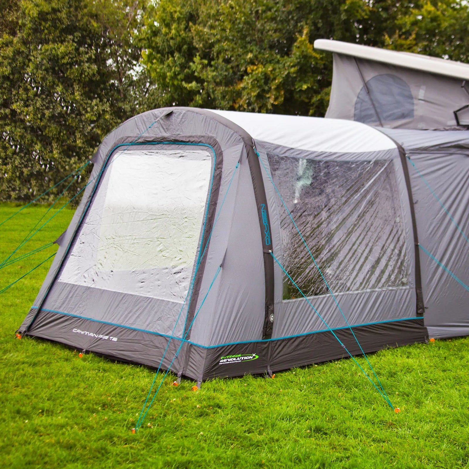 The Cayman Air T2 Low drive away awning in use, featuring its spacious interior and reliable weatherproof material from Outdoor Revolution. Perfect for campervan owners seeking an inflatable air awning.