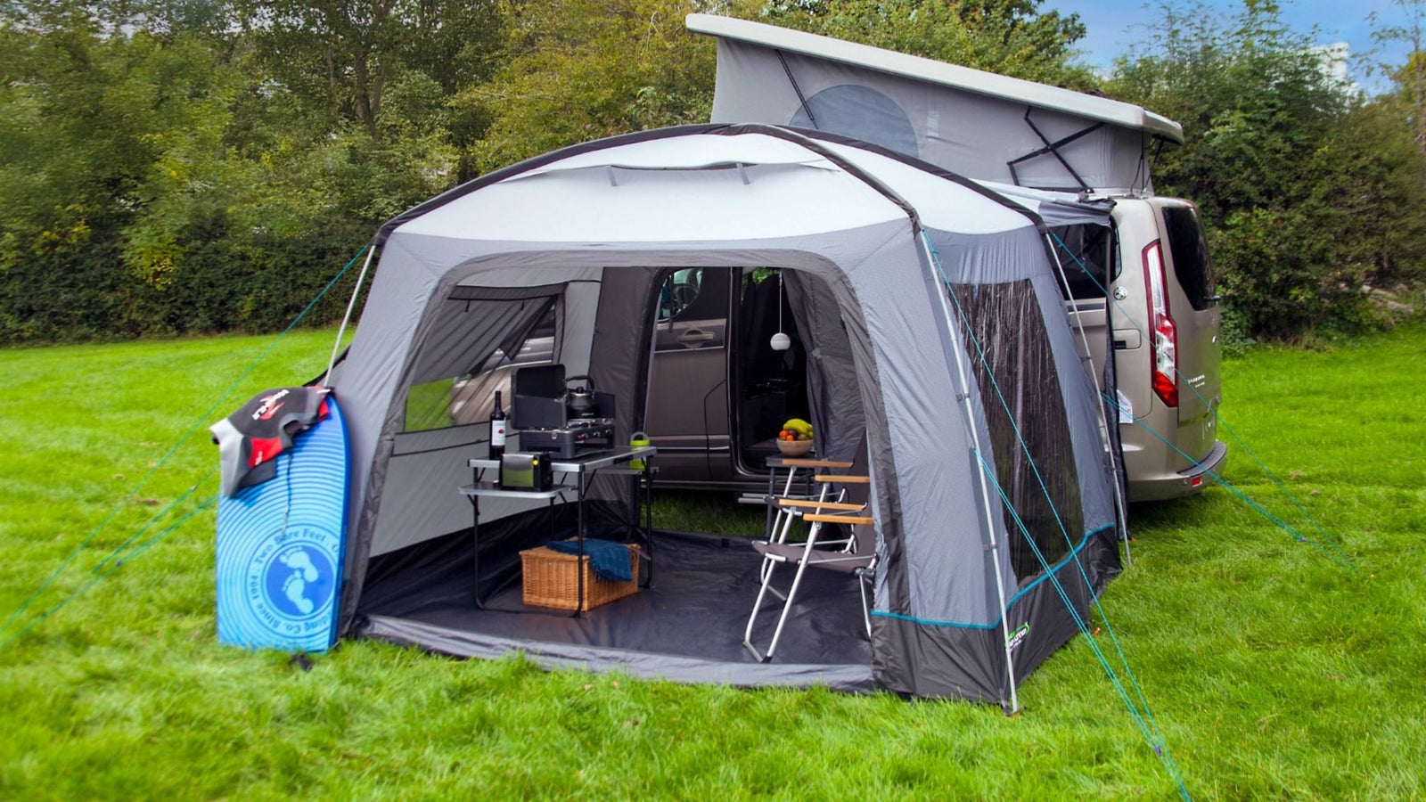 Outdoor Revolution Cayman Cuda XL F/G Drive Away Awning attached to a campervan, showcasing the spacious interior and fibreglass frame, ideal for creating additional living or dining space during camping trips.