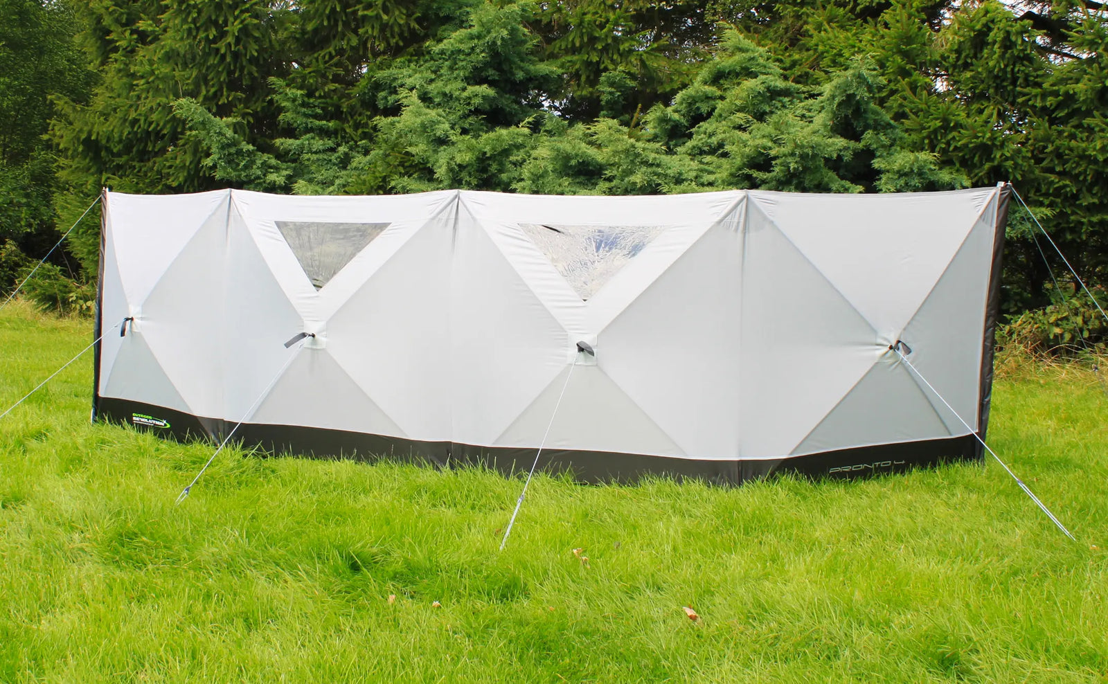 Outdoor Revolution Pronto 4 windbreak in use at a campsite, showing its stylish design and transparent panels for visibility and light.