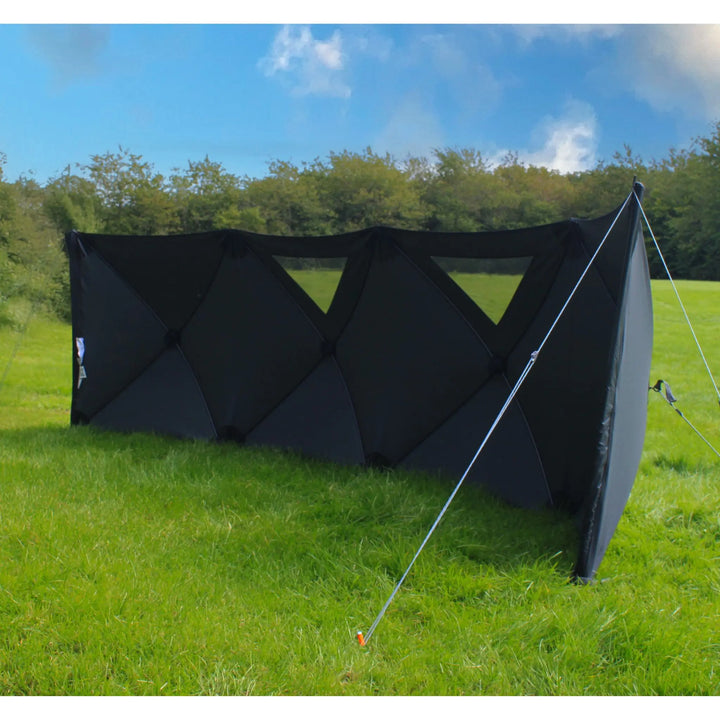 Outdoor Revolution Pronto Pro 4 Windbreak with guy ropes attached for stability, placed in a campsite setting.