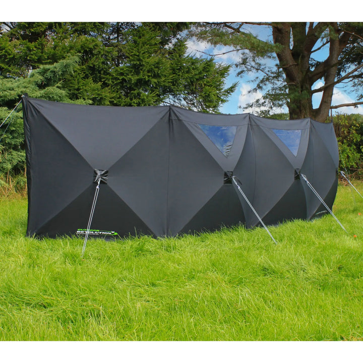 Close-up of the Outdoor Revolution Pronto Pro 4 Windbreak showing panel detailing and attachment points on grass.