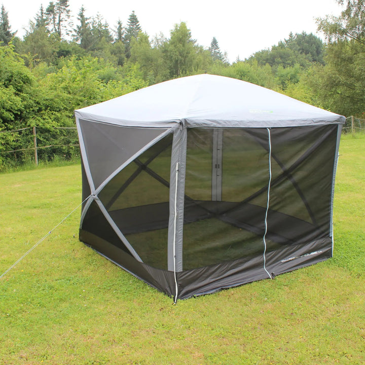 Outdoor Revolution Screenhouse 4 shelter fully closed, showing mesh panels and secure guy lines in a grassy campsite setting.