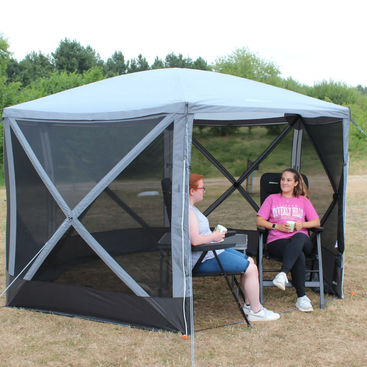 Outdoor Revolution Screenhouse 6 shelter viewed from an angle, showing its mesh sides and sturdy frame in a camping area.