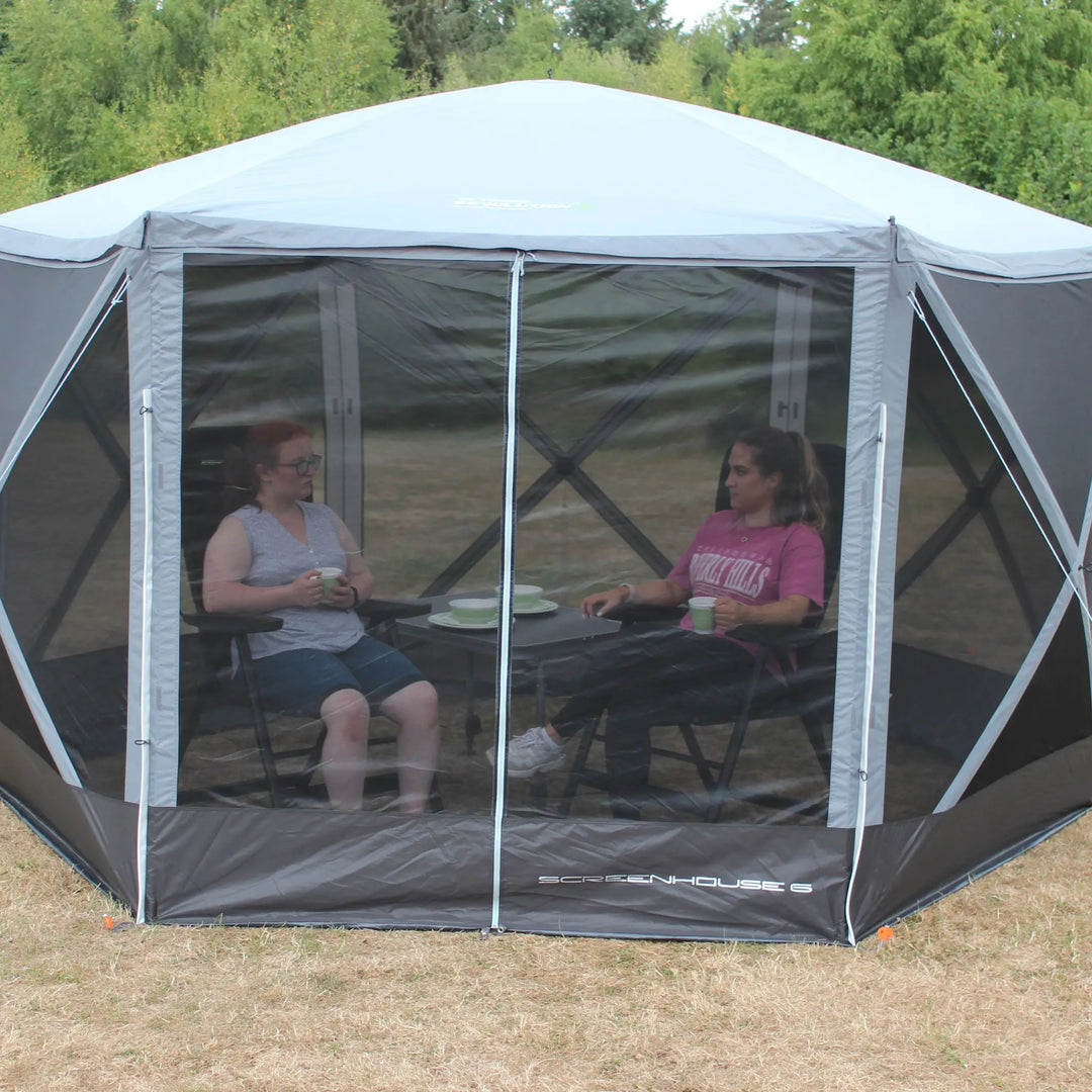 Outdoor Revolution Screenhouse 6 shelter with its zippered door fully closed, providing a clear view of its protective mesh design.