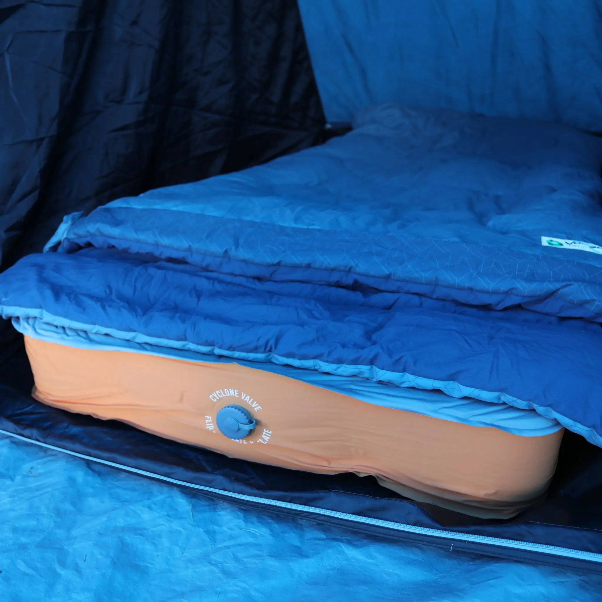 Close-up of a self-inflating camping mat with a cyclone valve for easy setup during camping.