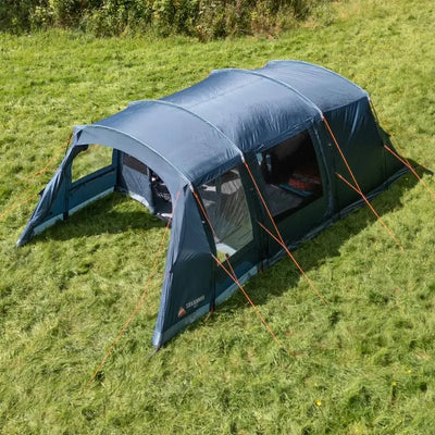 Blue Vango 4 person tent with afornt awning on a grassy field