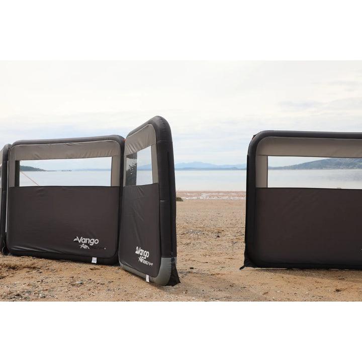 Vango AirBeam Modular Windbreak on a beach with ocean view.
