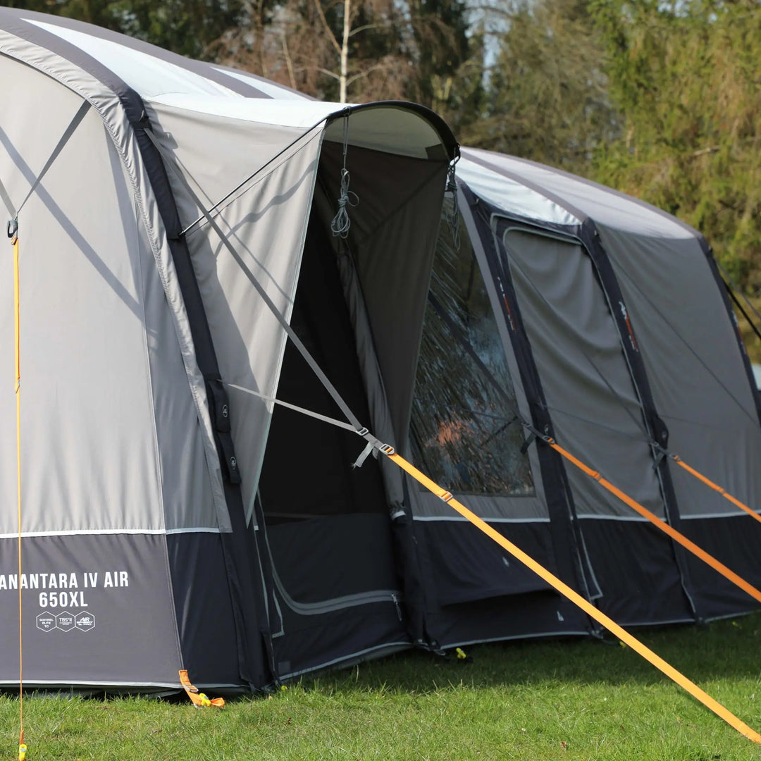 Side view of the Vango AirBeam Anantara IV Air 650XL family tent, showcasing the covered side door entrance for extra weather protection.