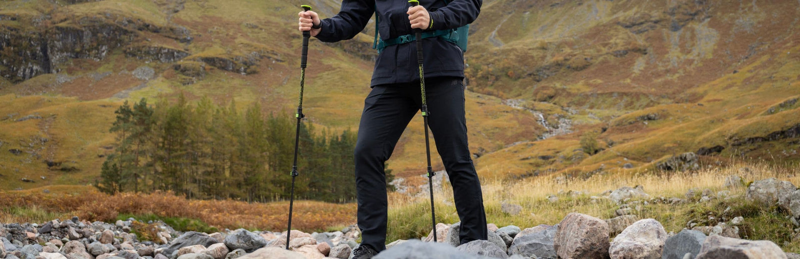 Hiker using Vango Annapurna Walking Poles in a rugged outdoor landscape, ideal for trekking and walking.