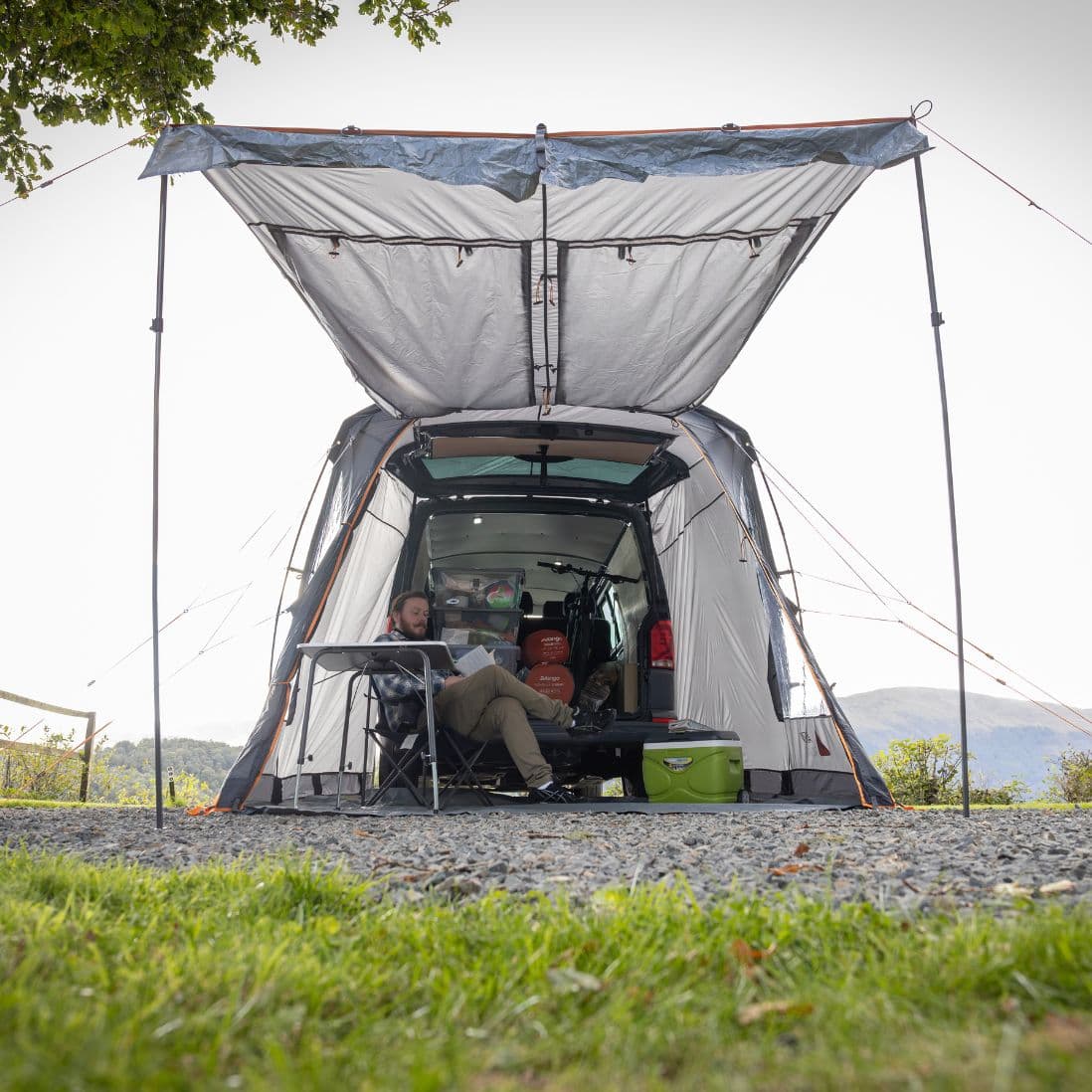 Rear view of the Vango Arden Tailgate Awning in use, with a campervan tailgate open to show interior.