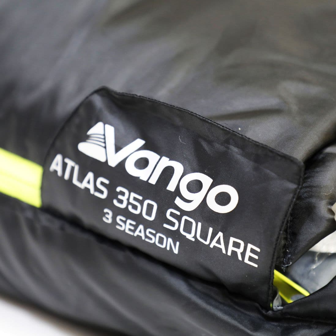 Close-up of the Vango Atlas 350 Quad sleeping bag tag, detailing it as a 3-season adult sleeping bag designed for comfort in various temperatures.