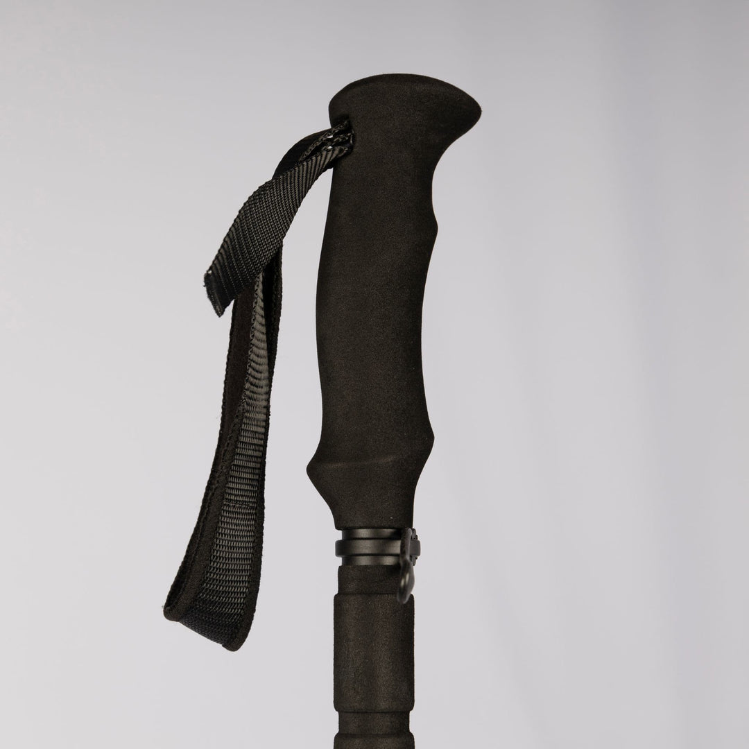 Ergonomic black handle of the Vango Basho Walking Pole, designed for comfortable trekking and hiking.