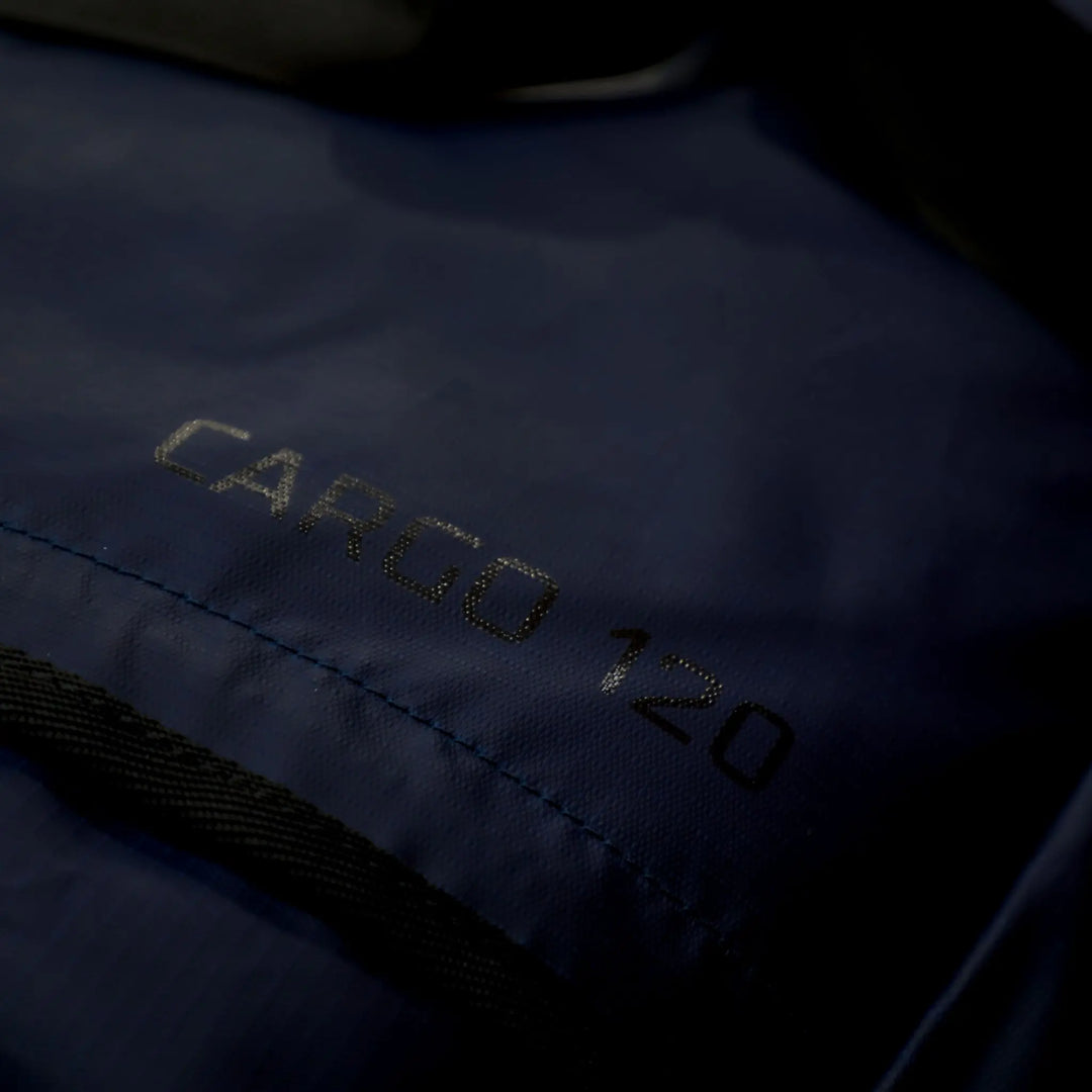 Close-up of the fabric label reading 'Cargo 120,' showcasing the capacity and quality of the Vango travel bag in Moonlight Ocean.