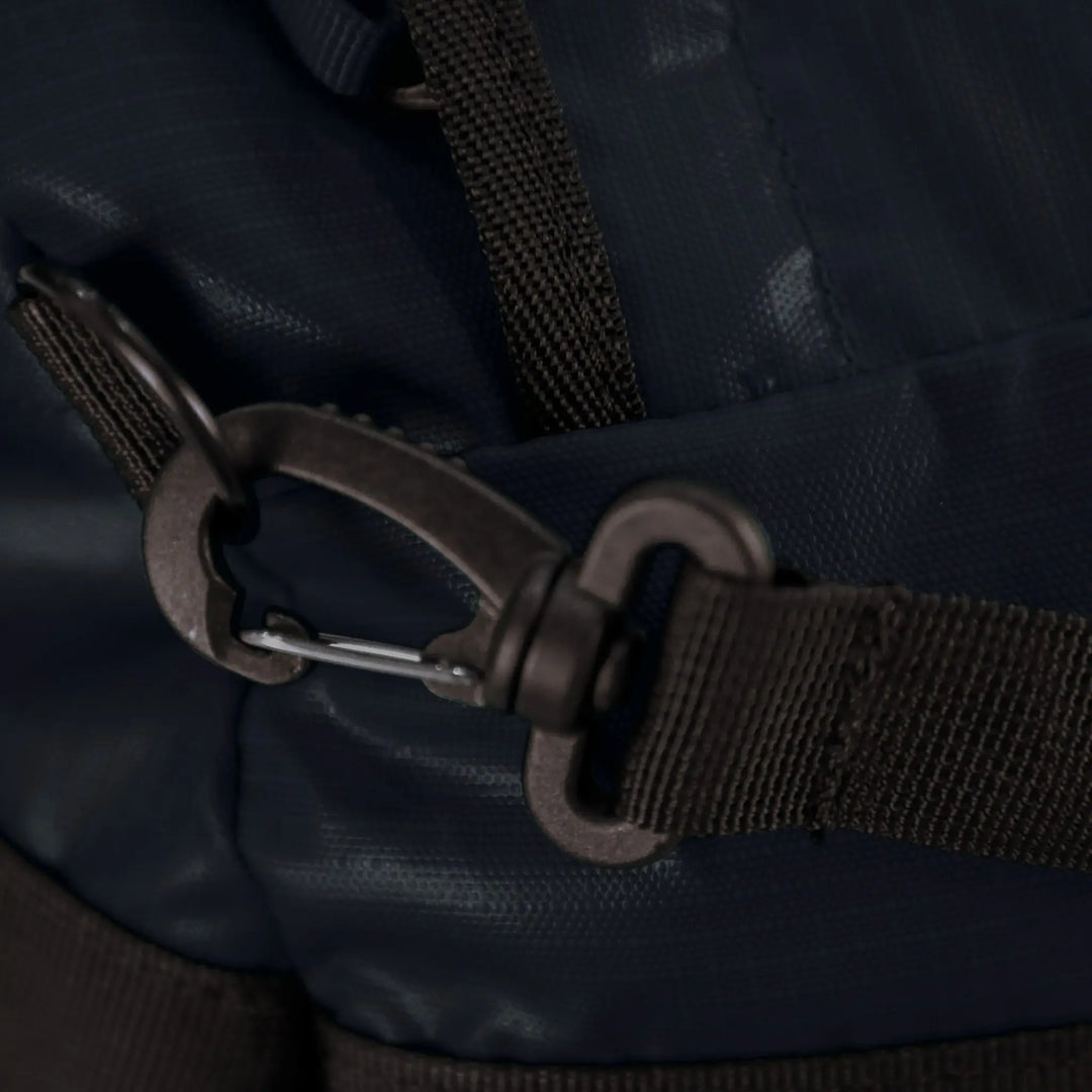 Detailed view of the buckle and strap on the Vango Cargo 120L travel bag in Moonlight Ocean, emphasizing secure fastening.