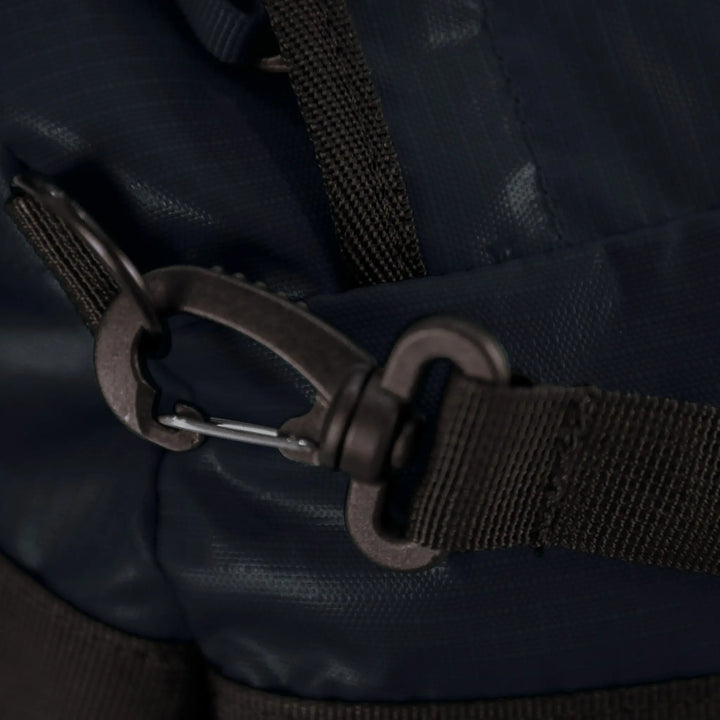 Detailed view of the buckle and strap on the Vango Cargo 120L travel bag in Moonlight Ocean, emphasizing secure fastening.