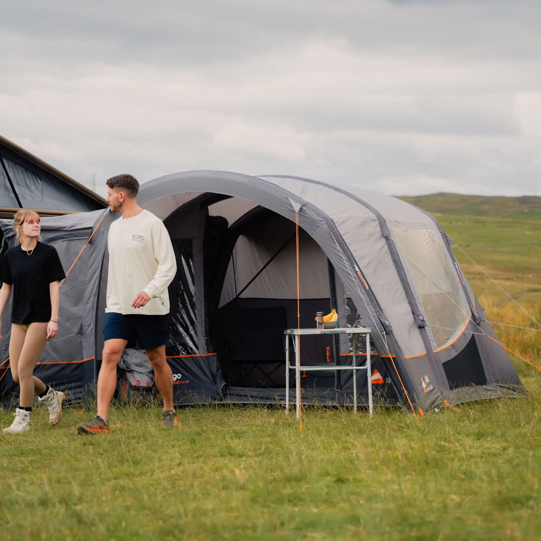 The Vango Cove III Air Low Awning attached to a campervan, showcasing its compatibility with low-height vehicles for camping.