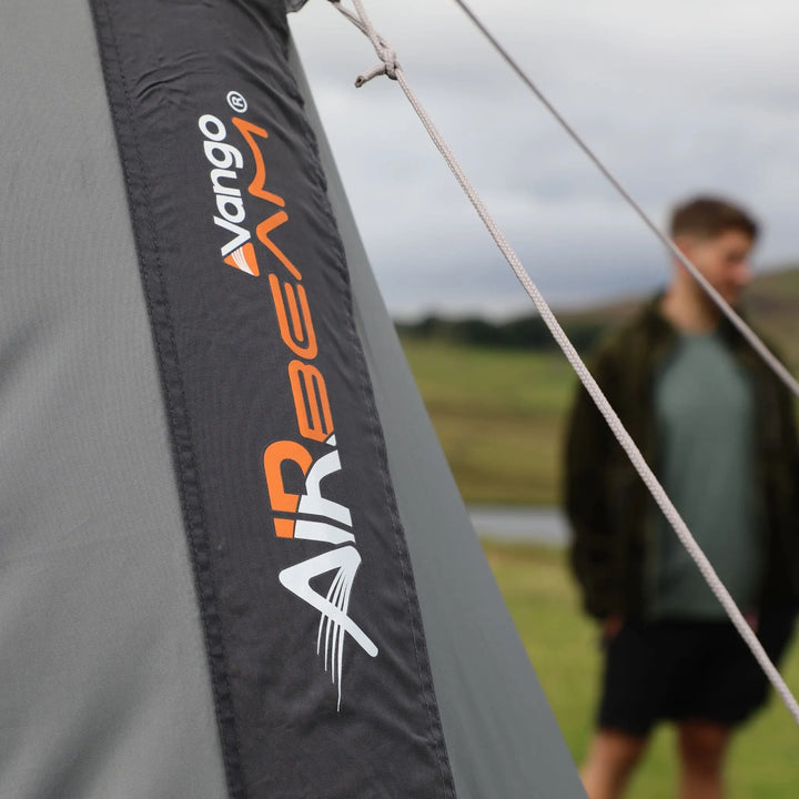 Close-up of the Vango AirBeam® logo on the awning's exterior canvas, illustrating durable design for camping use.