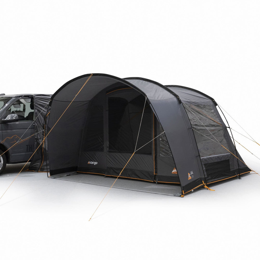 Side view of the Vango Cove III Low drive away awning connected to a campervan, highlighting its large secondary mesh panel front door and durable structure.