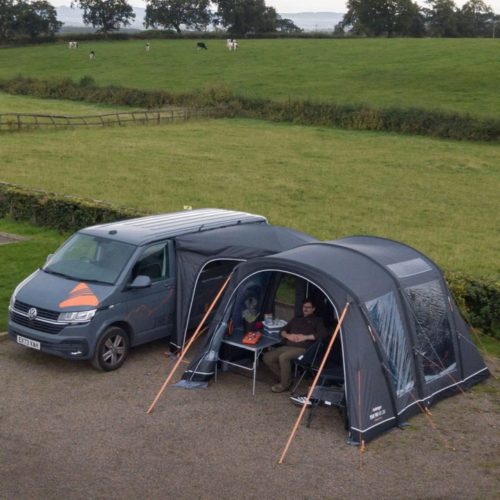 Lifestyle image of the Vango Cove Pro Air Low Drive Away Awning connected to a VW Campervan.
