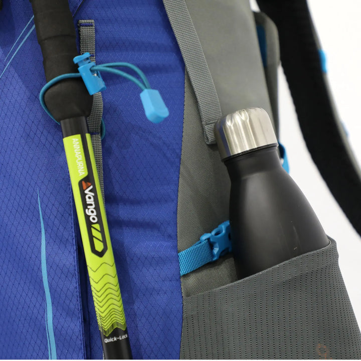 Side view of the Vango Denali Pro 60:70 rucksack showing a walking pole attachment and bottle pocket, perfect for DofE and long hikes.