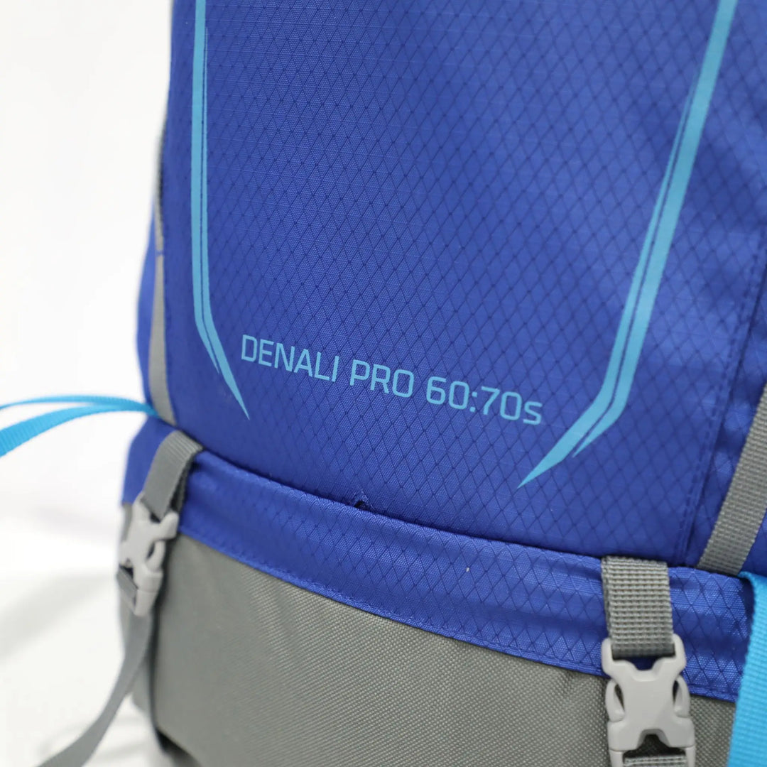 Side view of the Vango Denali Pro 60:70S rucksack in classic blue, featuring the reflective logo and durable Excel® Eco 600D fabric, ideal for DofE use.