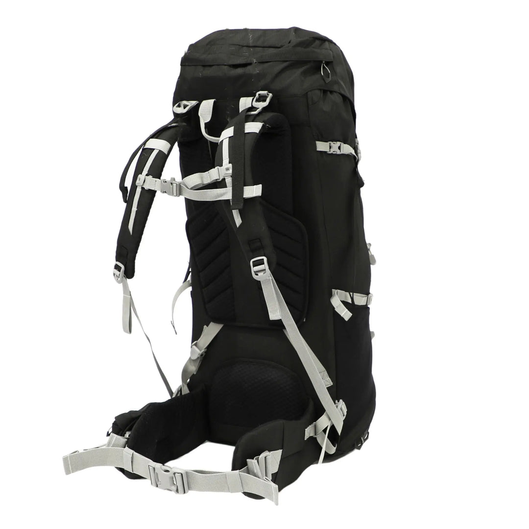 Side view of the Vango Denali Pro 70:80 black rucksack, showcasing compression straps and easy-access pockets for hiking essentials.