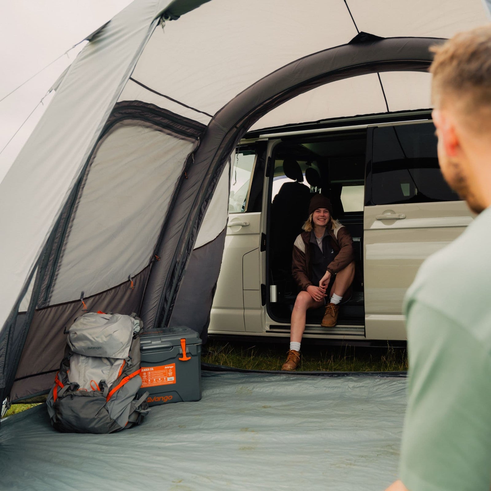 Interior shot of the Vango Faros III Air Low Air Awning connected to a VW campervan, showing the spacious layout and easy access between the vehicle and awning.